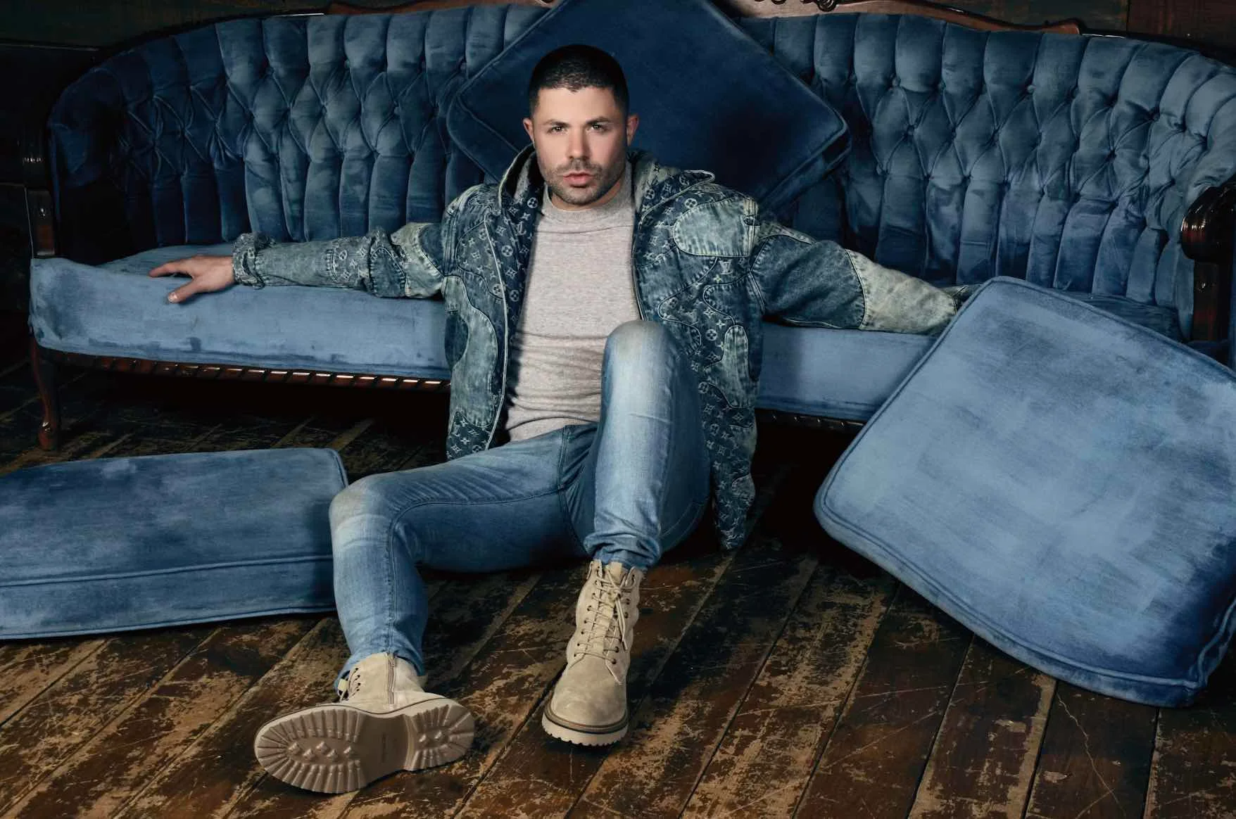 Jeffrey Wachman seated on a blue sofa